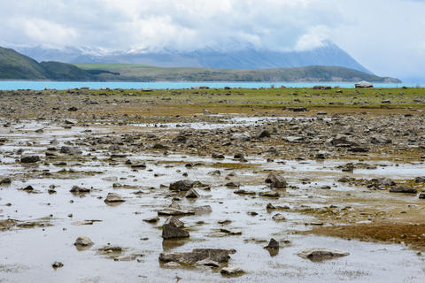 Shallow water at Lake Tekapo reveals a lot of small stones