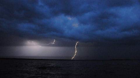 Thunderstorm and lightning over lake in the night