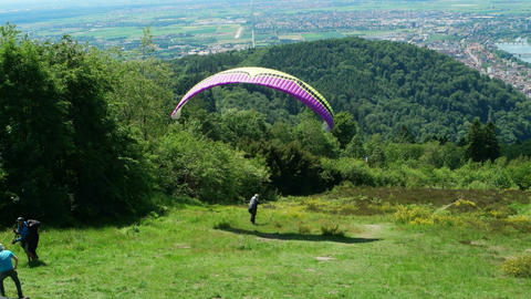 HEIDELBERG, GERMANY - JUNE 01, 2019: Two paragliders start from the Koenigstuhl near Heidelberg in