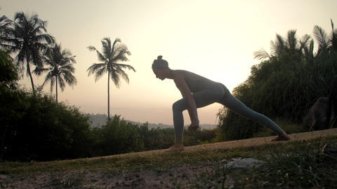 yoga practitioner does surya namaskar on road slow motion