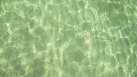 Girl swims in clear colorful transparent water