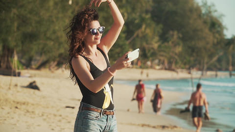 Happy woman making selfie on the beach