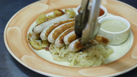 Traditional German food plate. sausage, cabbage, fried potatoes, ketchup and