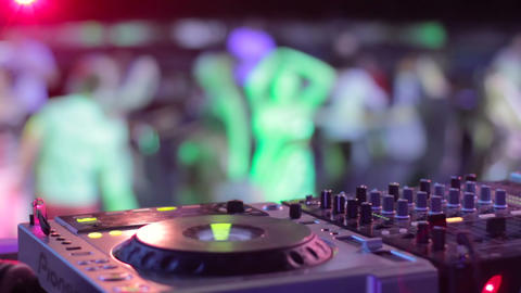 DJ hands in strobe lights at elite party in best nightclub