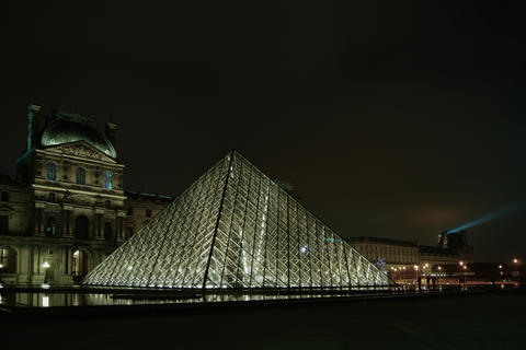 PARIS - MAY 11: Front of the Louvre, with Pyramid illuminated in Paris, France