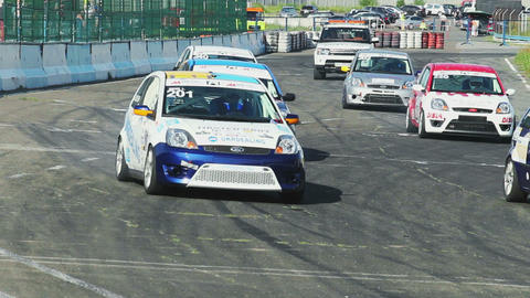 Start of the race, all cars roar and drive rapidly, competition beginning