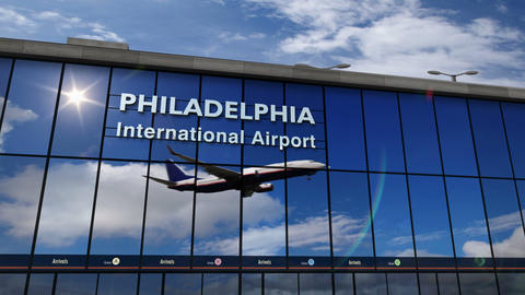 Airplane landing at Philadelphia mirrored in terminal