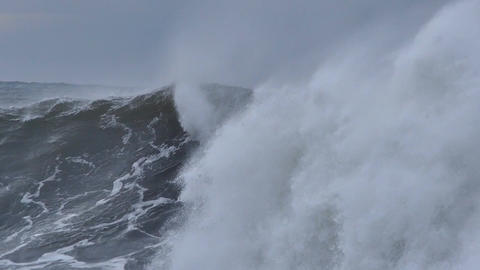 Big ocean sea waves crashing on coastal rocks during storm
