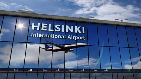 Airplane landing at Helsinki mirrored in terminal