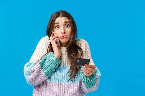 Gloomy and indecisive confused cute girl calling bank service cant understand