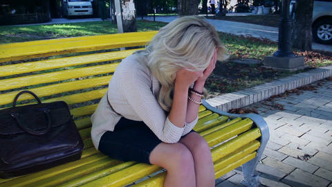 Depression and problems of blond female in park, crying tears