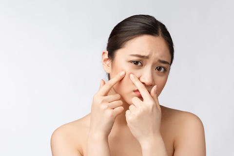 Face Skin Problem - young woman unhappy touch her skin isolated, concept for