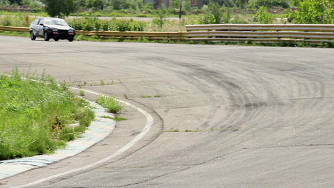 Race car drifting while taking sharp corner at high speed