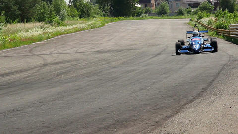 F1 racing car approaching, driver taking extremely sharp turn