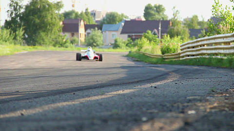 F1 race car rushing desert circuit, turning sharp, focus