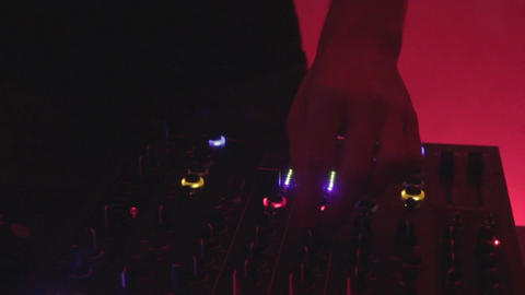 Dj's hands on mixing sound board, party in the nightclub