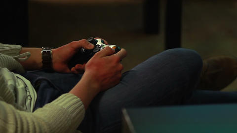 Video gamer plays game with joystick, enjoying action strategy