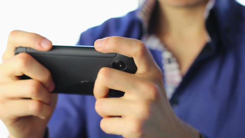 Man playing sensor games on touch phone, YES, losing, close-up