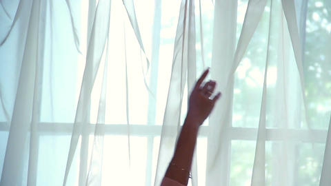 Professional female dancer lifts hands gracefully above her head