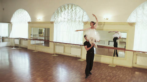 Ballet dancers in the studio, man carrying woman on shoulder