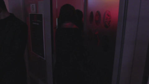Young people entering, leaving night club, open, close door