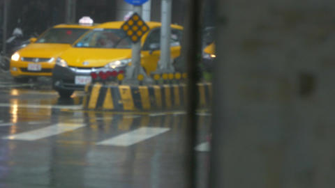 Pedestrian struggles to cross street in typhoon wind and rain