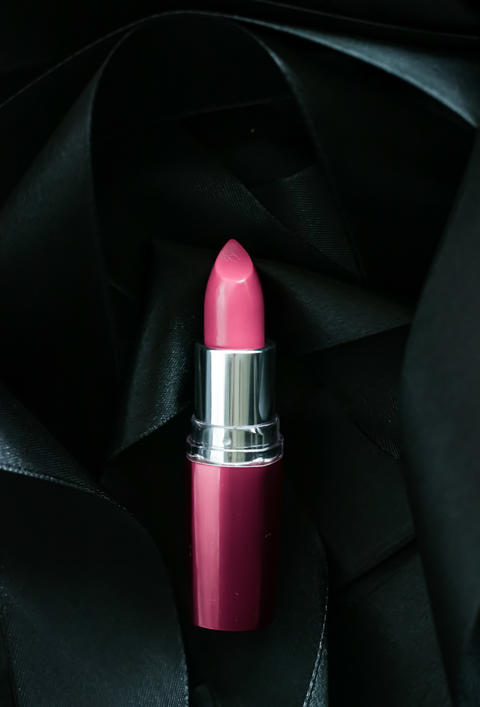 Pink lipstick on black silk background, luxury make-up and beauty cosmetic