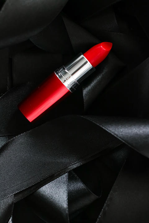 Red lipstick on black silk background, luxury make-up and beauty cosmetic