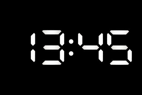 Real white led digital clock on black background