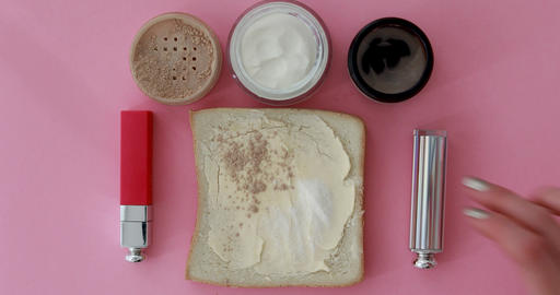 Crop woman with makeup products on pink table