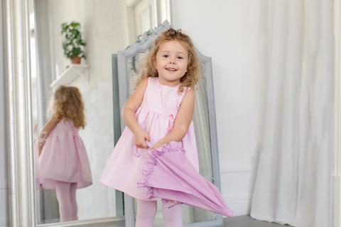 Adorable little girl with umbrella white interior