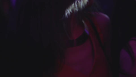 Brunette in red dress dancing in night club, party atmosphere, active lifestyle