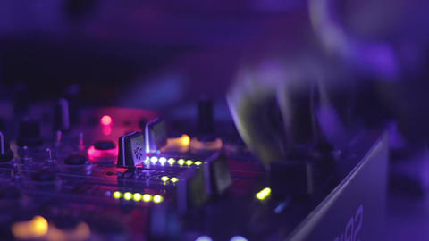 Close-up video of female dj hands playing music at the nightclub. Mixing console