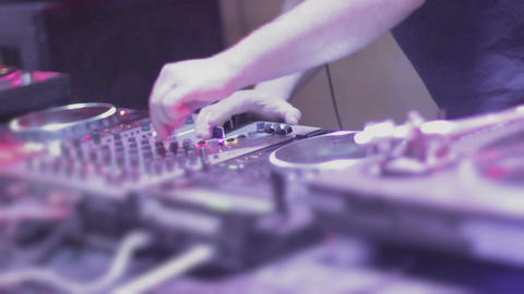Crowd of young people partying on dancefloor, DJ playing set. Nightclub sequence