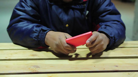 Male playing on his mobile phone. Pleasure. Dependence on gadgets, problems