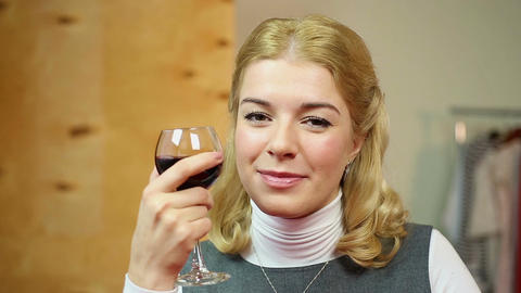 Pretty woman drinking red wine, flirting with her boyfriend in cafe, smiling