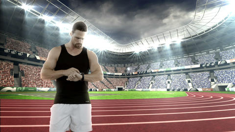 Male athlete setting a smartwatch while warming up