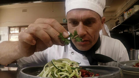 Male chef garnishing food