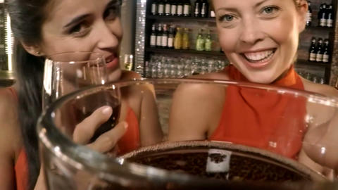 Female friends having glass of beer