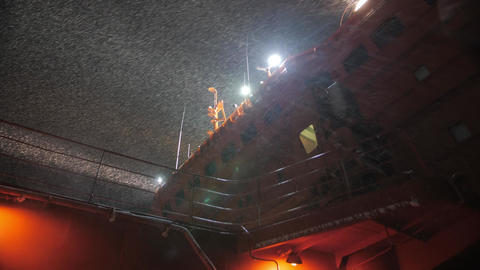 deck of Nuclear Icebreaker sail in the night. Snowfall