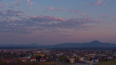 Colorful aerial hyper lapse of sunset above small town