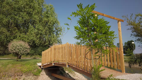 Wooden footpath across water, garden design and landscaping