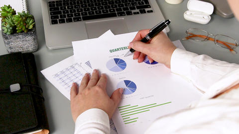Business woman hands working with documents close up