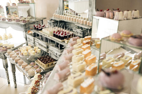Beautiful bright buffet with many sweet snacks a candy bar on a white table and