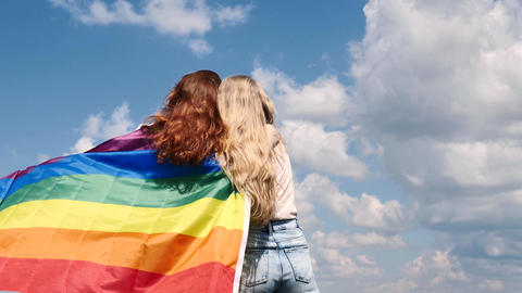 LGBT Couple holds a rainbow flag