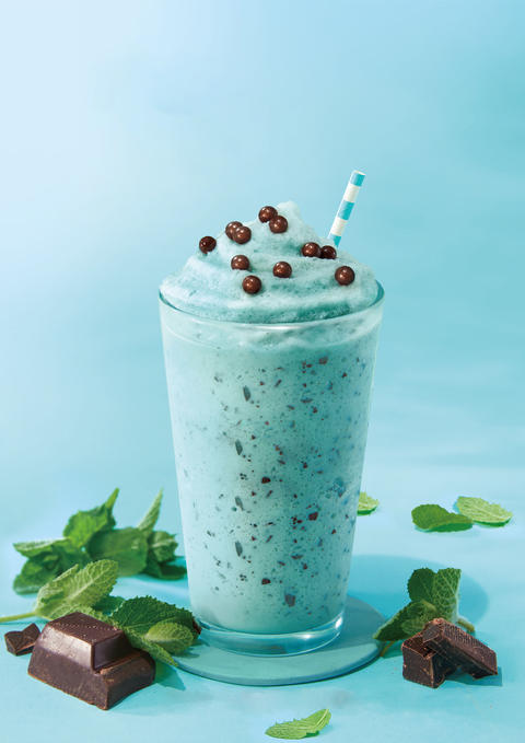 Mint chocolate milkshake on turquoise color background