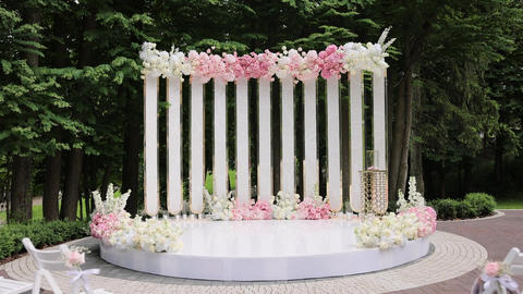 Beautiful Wedding decor. Wedding arch with fresh flowers on summer sunny wedding