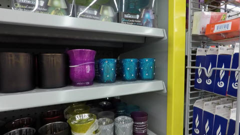 Decorative scented candles and candle holders on store shelves