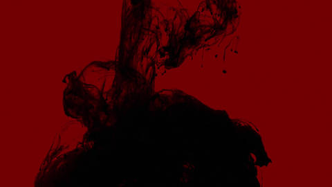 Black Ink Drop on Red Backdrop