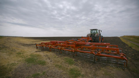Harvesting in the field. Land cultivation with a tractor